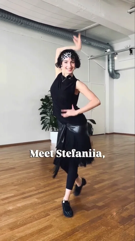 Stefaniia dancing alone in the studio, one arm above her head